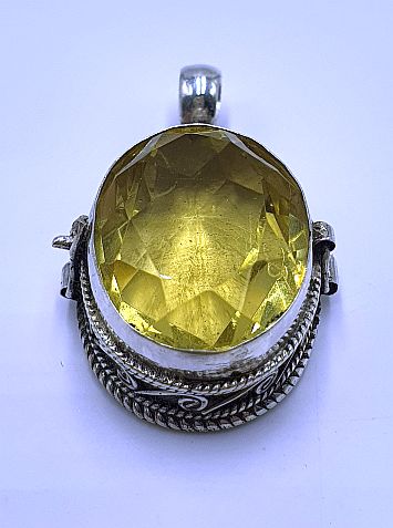 Silver ghau with golden topaz stone.