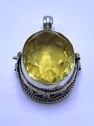 Silver ghau with golden topaz stone.