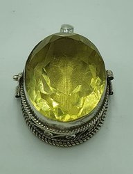 Silver ghau with golden topaz stone.