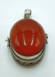 Silver ghau with red onyx stone.